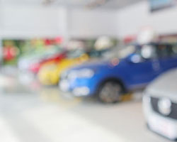 blurry image of car dealership showroom
